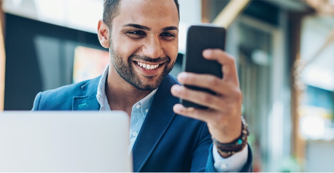 man on his cell phone buying funds